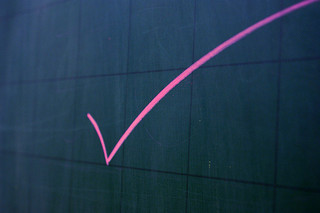 pink checkmark on black board